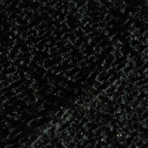 Texture d'une feuille de papier texturée noire en lumière rasante